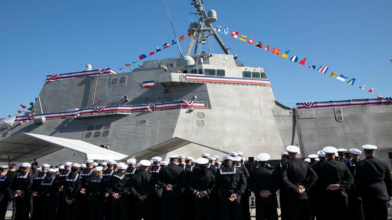 The crews of USS Canberra and HMAS Canberra stand on parade at the commissioning ceremony of USS Canberra.
