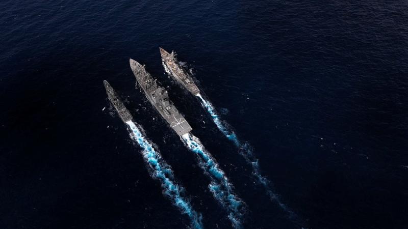 JS Oumi conducts a duel Replenishment at Sea with HMAS Arunta, left, and USS Milius, right, during Exercise Malabar 2022.