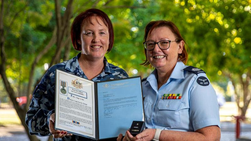 From left, Chief of Staff Combat Support Group, Group Captain Melissa Neilson presents Warrant Officer Kylie Terry with a Federation Star.