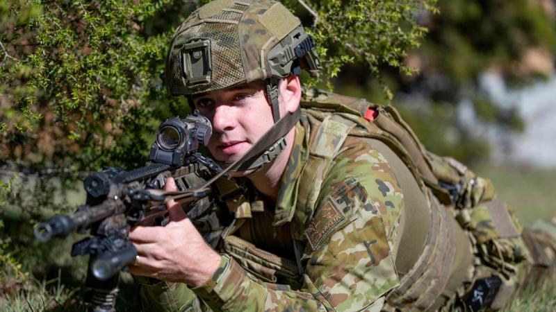 Australian Army reserve soldier Private Cameron Parkinson looks down the scope of a EF88 Austeyr rifle.