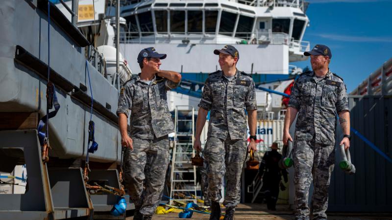 NUSHIP Arafura sailors Leading Seaman Jack Bellingham, Able Seaman Joshua Keys and Leading Seaman Joshua Guy walk the deck of ADV Reliant.