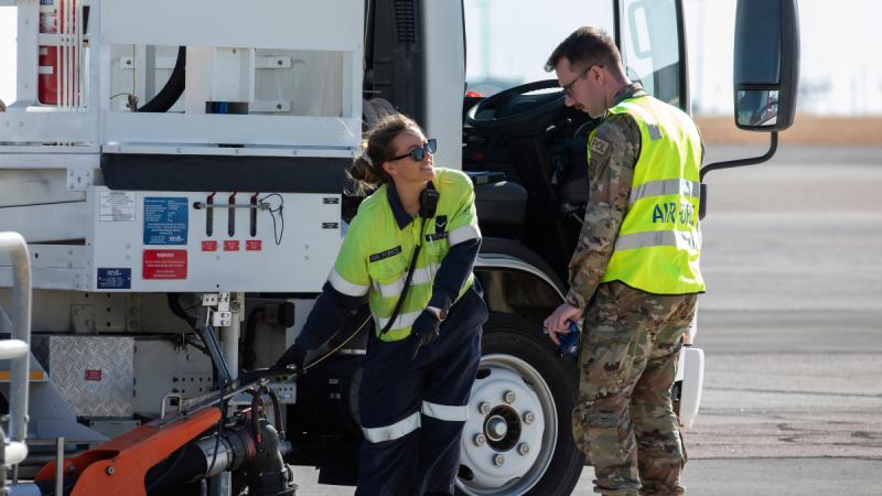 Royal Australian Air Force and United States Air Force refuelling specialists discuss the refuel of a KC-135 following it's arrival at RAAF Base Darwin in the Northern Territory for Exercise Mobility Guardian 23.