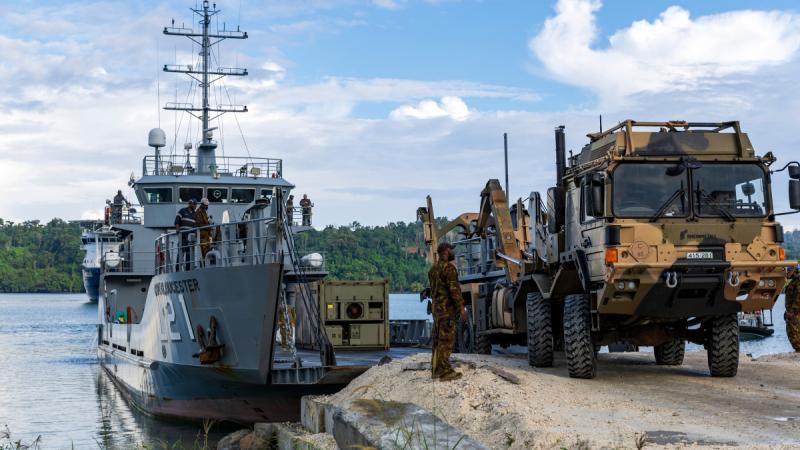 An Australian Army vehicle driving ashore on Manus Island from HMPNGS Cape Gloucester.