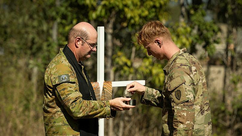 Chaplain Major Haydn Parsons serving communion to United States Army personnel.