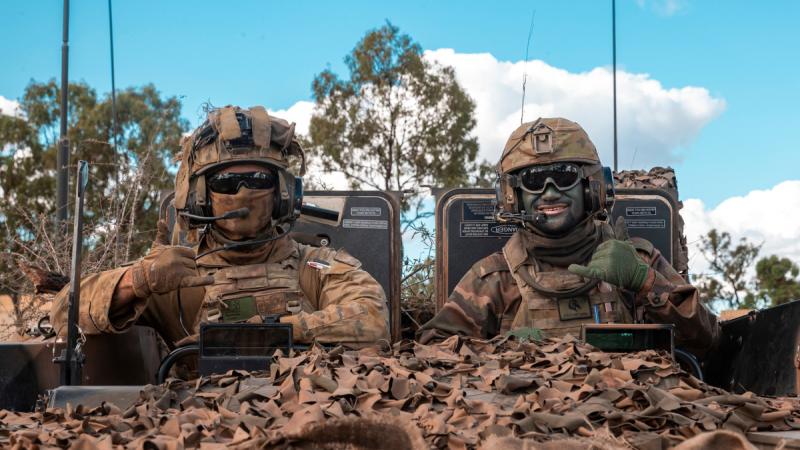 Australian Army Private Samuel Austen-Wilkins (left) and His Majesty's Armed Forces - Tonga, Lance Corporal Sione Atoa, mounted in an Australian Army Boxer Combat Reconnaissance Vehicle during Talisman Sabre 23.