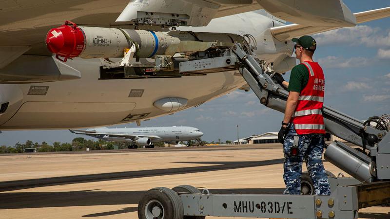 Leading Aircraftman Zachary Sellmann, from 11 Squadron, fits an ATM-84 harpoon anti-ship missile to a P-8A Poseidon during Exercise Talisman Sabre at RAAF Base Darwin. 