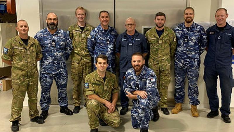 A group of defence personnel posing for a picture.  