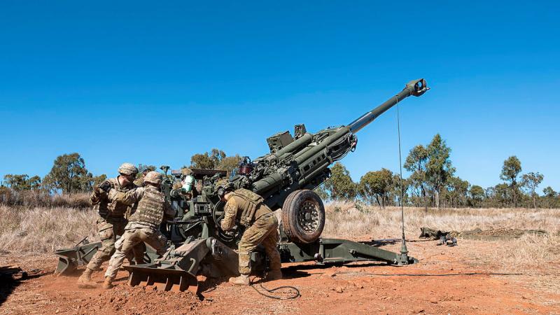 Army soldiers from Australia's 4th Regiment, Royal Australian Artillery and United States' 11th Field Artillery Regiment work together during a combined arms live-fire serial on Exercise Brolga Sprint 23 at Townsville Field Training Area, Queensland. Photo: Lance Corporal Riley Blennerhassett