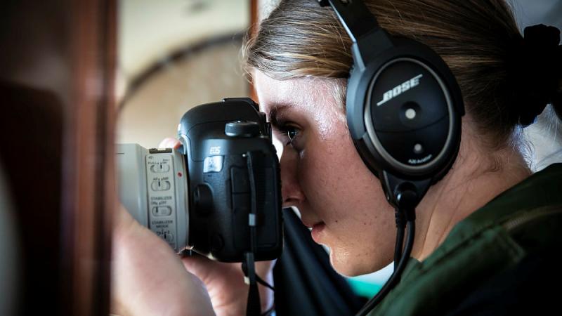 Aircraftwoman Bethany Griinke taking pictures.