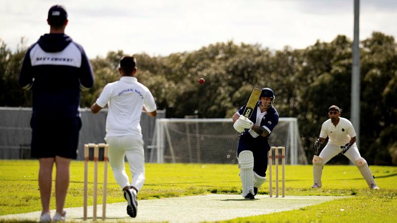 Leading Seaman Physical Training Instructor Corey Evans hits the ball as personnel from the Indian and Australian navies compete in a game of cricket as part of Exercise Malabar’s shore phase in Sydney, NSW. 