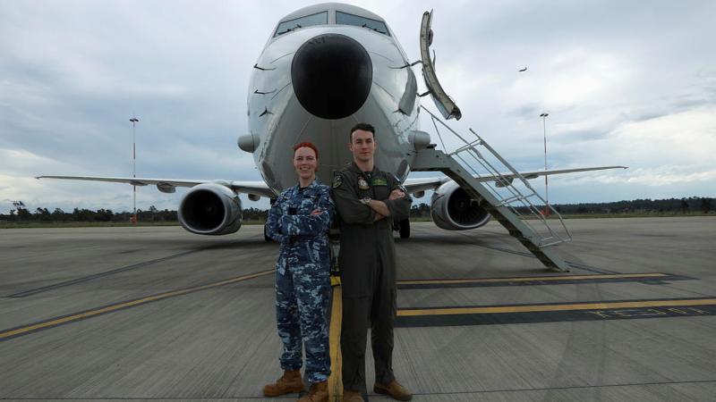 Leading Aircraftwoman Buj Nike and Flying Officer Lincoln Rolfe stand in front of a P-8A Poseidon aircraft 