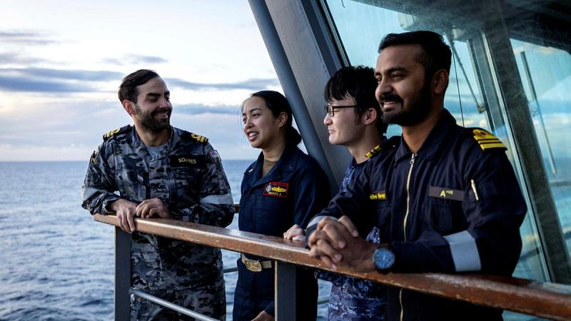 International partners discuss an exercise plan on board a Navy ship.