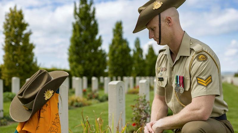 Australian Army Jonathan Church Good Soldiering Award ambassador Corporal Justin Wells, beside the headstone of Gunner William Tasker at Villers-Bretonneux Military Cemetery, Villers-Bretonneux France. 