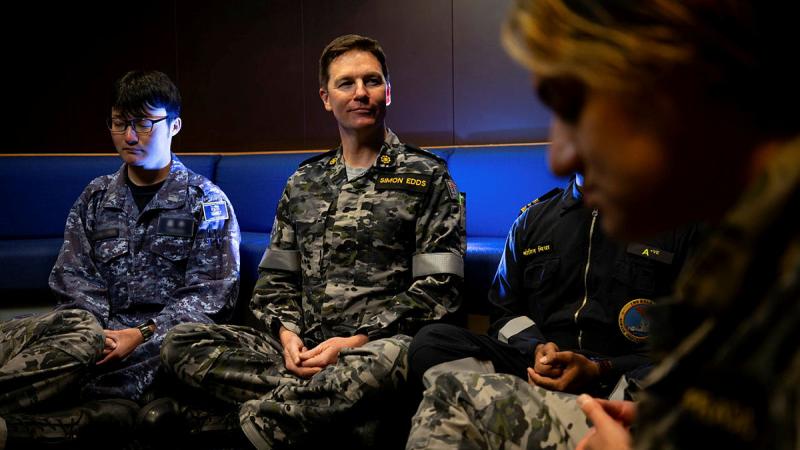  Navy Chaplain Simon Edds guides a meditation session on board HMAS Choules during Exercise Malabar, NSW.
