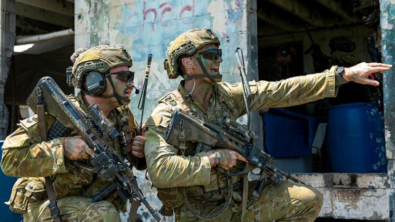 Australian Army soldier Corporal Brandon Camilleri, right, delivers quick orders during a bilateral air assault exercise with the Armed Forces of the Philippines on Exercise Alon in the Philippines. 