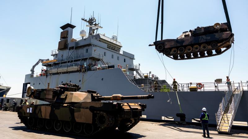 An Australian Army M1A1 Abrams main battle tank is unloaded from the United States Army Vessel SSGT Robert T. Kuroda at Tanjung Perak Port in Indonesia during Exercise Super Garuda Shield 2023.