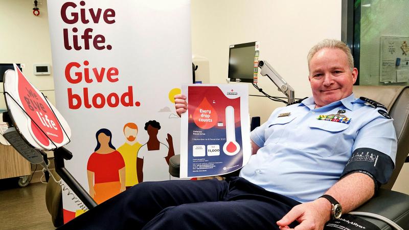 Group Captain Mike Burgess-Orton donating blood. 