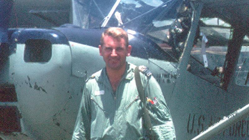 Flight Lieutenant Garry Cooper (ret) during the Vietnam War in front of a U.S Air Force O-1 Bird Dog.