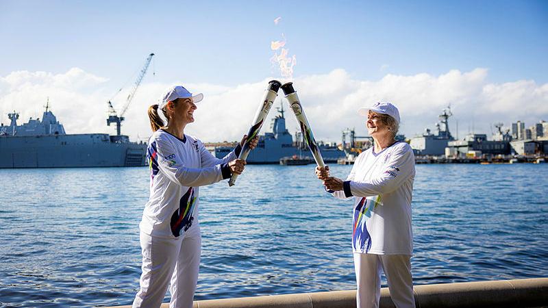Commander Cindy Jenkins, left, during her stint as a torch bearer in the Legacy Centenary Torch Relay, to recognise 100 years of the Legacy Promise. 