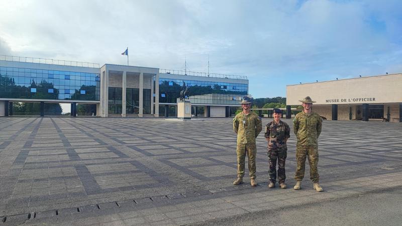 Australian Army officer Captains Jordan Lynch (right) and Kurt Raike (left), of the Royal Military College-Duntroon, with Lieutenant Colonel Alexandra Joly, Head of International Affairs Saint-Cyr, in front of the Saint-Cyr Parade Ground, France.