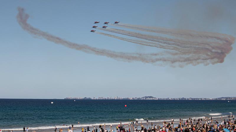 The Royal Australian Air Force aerobatic team, the Roulettes, fly past crowds at the Pacific Airshow Gold Coast.