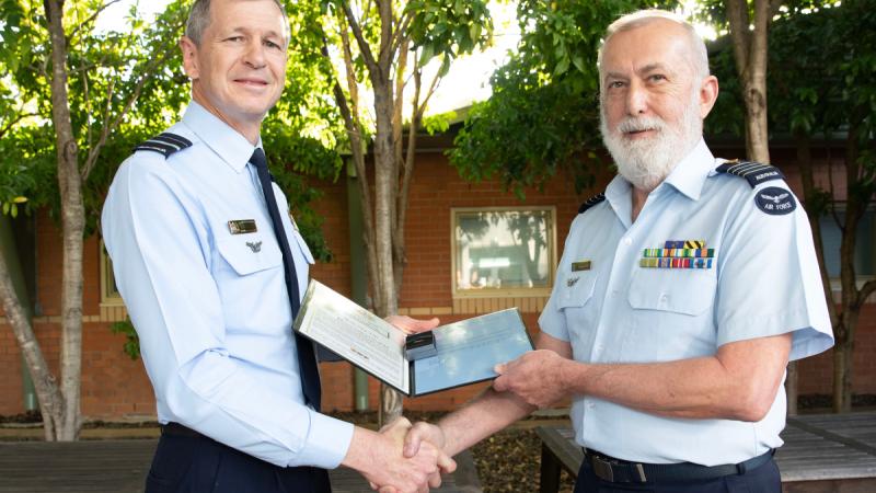 Group Captain Graeme Peel (right) being presented with the 6th clasp to his Defence Long Service medal by Air Commander Australia, Air Vice-Marshal Glen Braz.