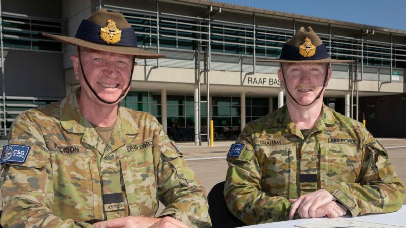Outgoing Commander Combat Support Group Air Commodore David Paddison, left, incoming Commander Combat Support Group Air Commodore Robert Graham sign the handover/takeover documents during the change-of-command ceremony at RAAF Base Amberley.