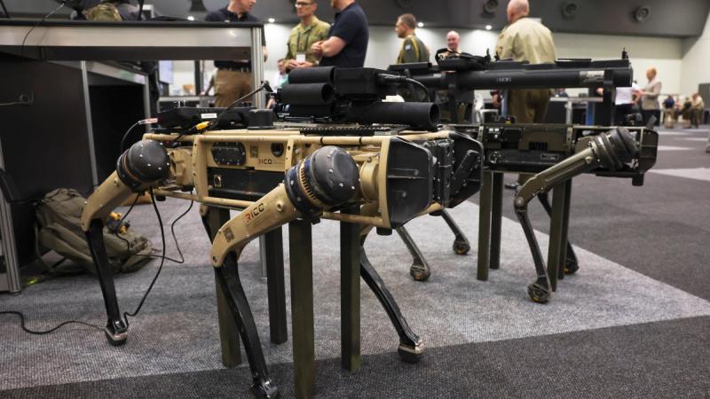 Quadrupedal uncrewed vehicles, colloquially known as ‘robot dogs’, fitted with mock weapons on display at the Army Robotics Expo as part of the Chief of Army Symposium 2023 in Perth.