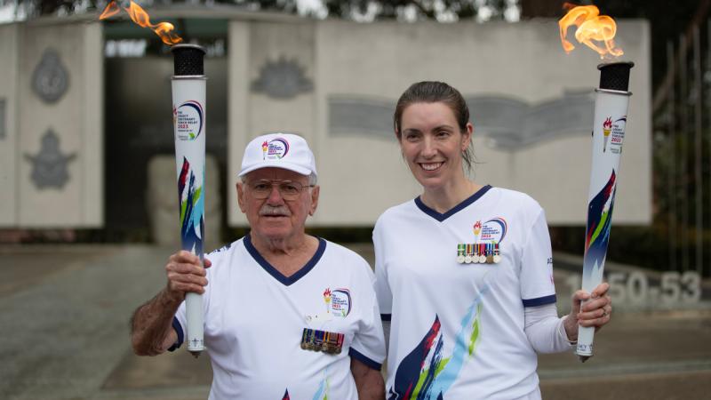 Vietnam veteran Mr Ray Sunderland and former Royal Australian Navy pilot Ms Kate Munari during the Legacy Centenary Torch Relay 2023 on Anzac Parade in Canberra.