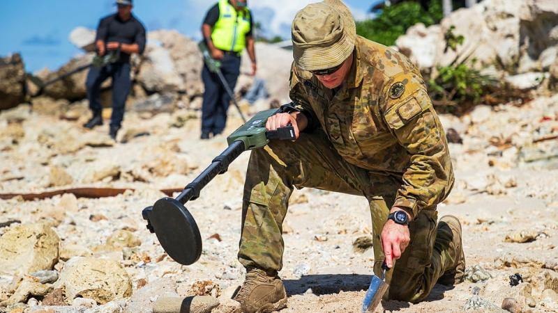 Australian Army Lance Corporal Lobenzo Humberto Meneses inspects an area of interest during Operation Render Safe, Nauru.