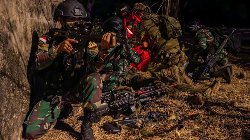 An Indonesian soldiers stands watch during a night assault exercise.