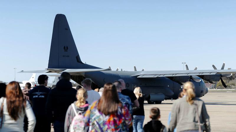 Families of 37 Squadron personnel prepare to board a C-130J Hercules for a flight during the squadron's Family Day at RAAF Base Richmond. Photos: Corporal John Solomon