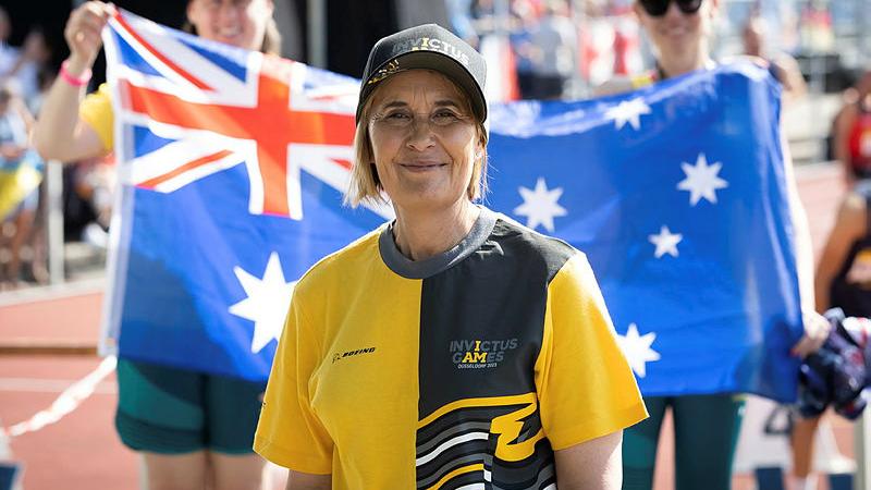Mrs Fiona Viney in front of an Australian Flag at the Merkur Spiel-Arena, Dusseldorf, Germany.