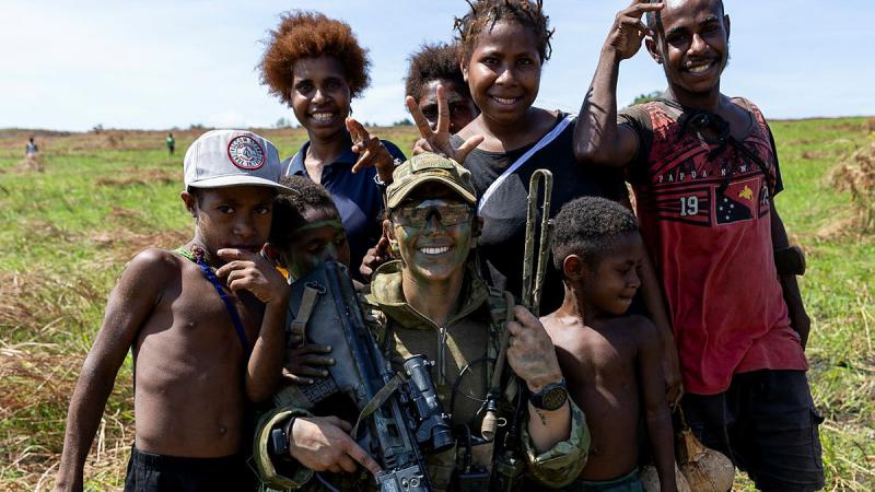  Australian Army officer Lieutenant Samantha May from the 3rd Battalion, The Royal Australian Regiment, with local children, Papua New Guinea. Photos: Leading Aircraftwoman Emma Schwenke