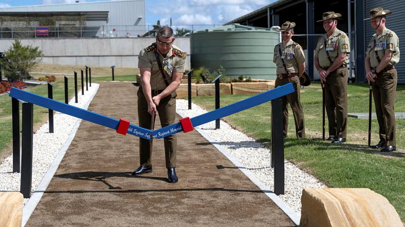 Commander 6th Brigade, Brigadier Greg Novak, uses the ceremonial axe to officially open the 6th Engineer Support Regiment Memorial Walk at RAAF Base Amberley, Queensland. 