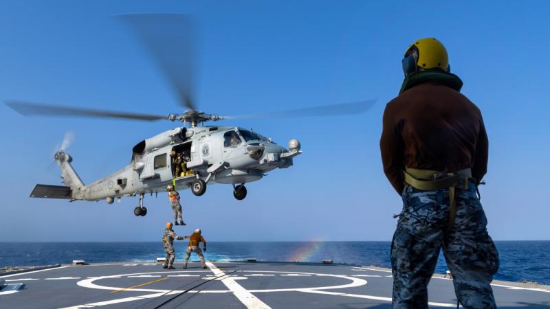 Royal Australian Navy sailors and officers from HMAS Toowoomba’s embarked MH-60R aircraft “Valkyrie” transfer passengers during an exercise off the coast of Western Australia.