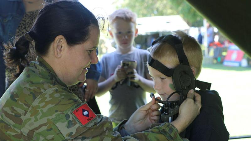 A young boy is fitted with an Army radio during 31st/42nd Battalion, The Royal Queensland Regiments Army Reserve Open Day. Photos: Susanna Beyer