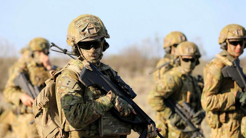 Soldiers holding their guns.