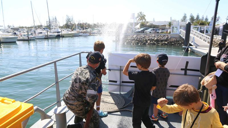 Leading Seaman Andrew Price demonstrates fire hose techniques during HMAS Maryborough’s open day.