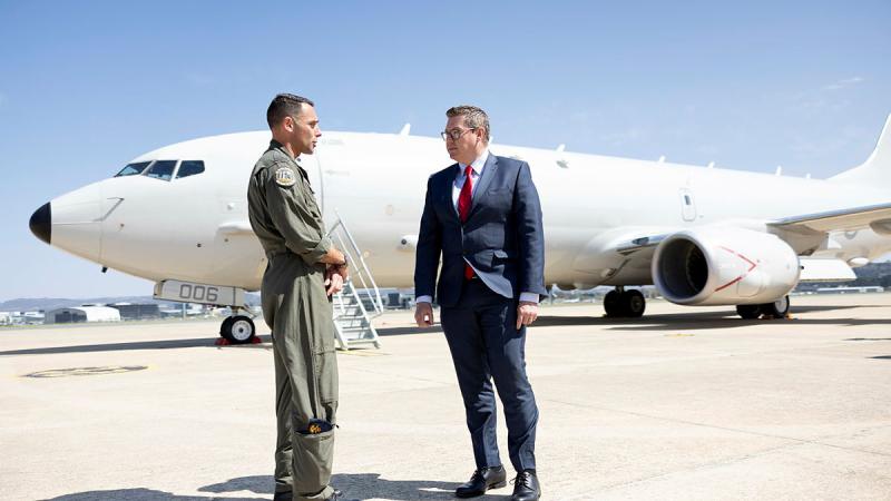 Commanding Officer of Air Force's 11 Squadron, Wing Commander Adam Saber, with Defence Industry Minister Pat Conroy and a P-8A Poseidon in Canberra.