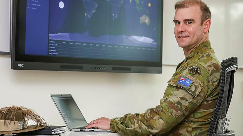 Major Thomas Bittner with laptop and space screen at RAAF Base Edinburgh.