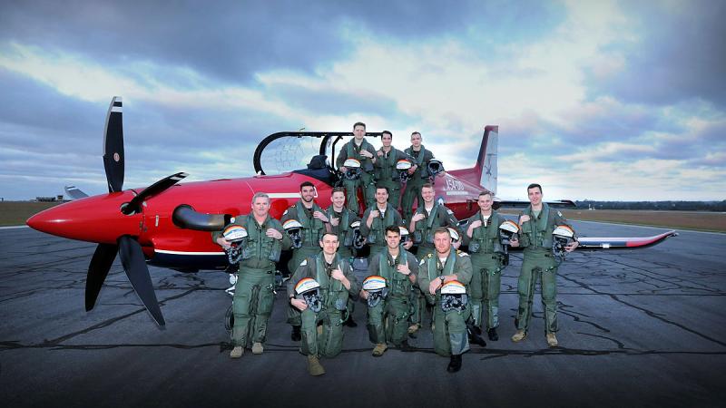 271 ADF Pilots’ Course members assembled at dawn on the flight line with a Pilatus PC-21 aircraft.
