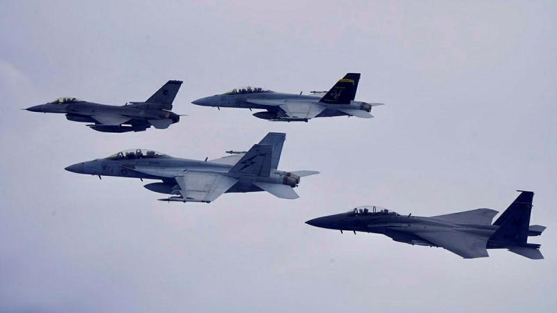 RAAF F/A-18F Super Hornet and Republic of Singapore Air Force, F-16 Fighting Falcon and F-15SG Strike Eagle aircraft fly in formation over Singapore.