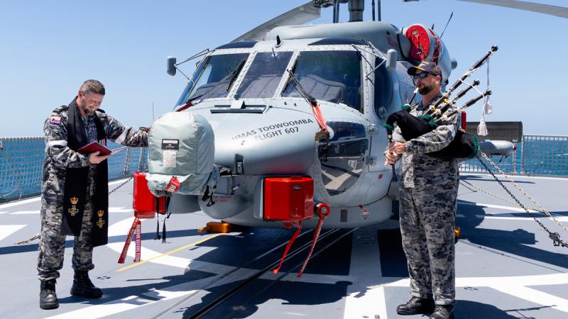 Royal Australian Navy Chaplain Bradley Galvin (left) and Commanding Officer of HMAS Toowoomba Commander Darin MacDonald during a blessing ceremony for the embarked MH-60R helicopter “Valkyrie”.