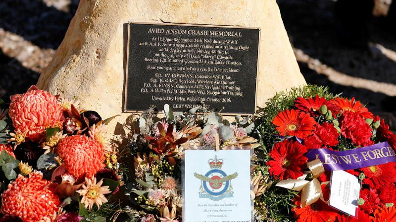 Wreaths adorn the foot of the Loxton Avro Anson Crash Memorial in Loxton.