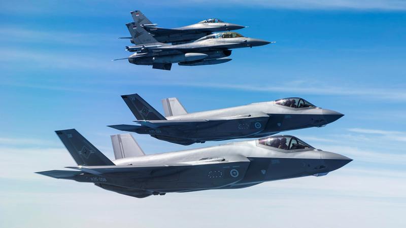 Two RAAF F-35A Lightning II's  fly with two TNI-AU F-16 Fighting Falcons.