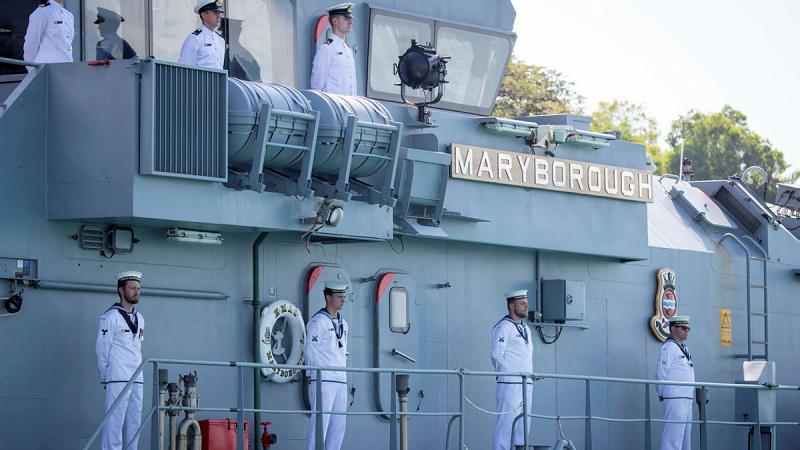 Ship's company line the upper decks of HMAS Maryborough during its decommissioning ceremony.