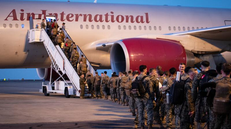 United States marines board an Omni Air International flight departing from RAAF Base Darwin, NT.