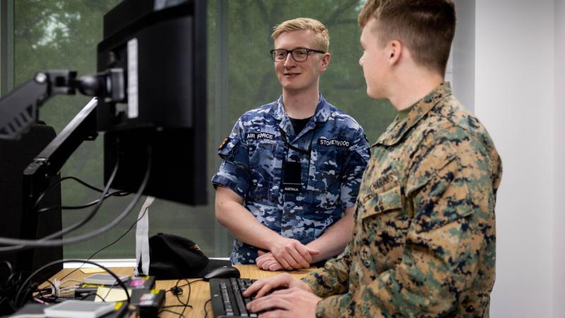 Royal Australian Air Force and US Marine members on a cyber warfare exercise.