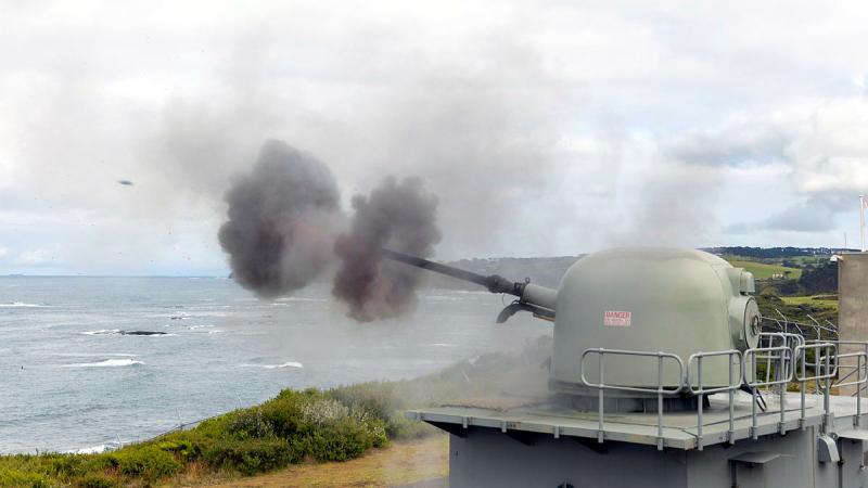 The 76mm medium calibre gun fires an 80-round burst at West Head gunnery range at Flinders, Victoria. Photos: Leading Seaman James McDougall